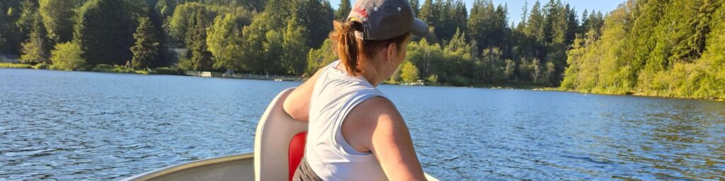 woman fishing with husband in aluminum boat on lake