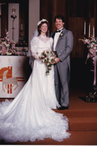 woman and man smiling at altar for wedding photo
