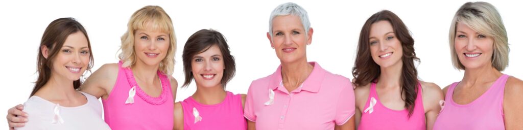 six middle-aged female friends wearing pink shirts with cancer ribbons