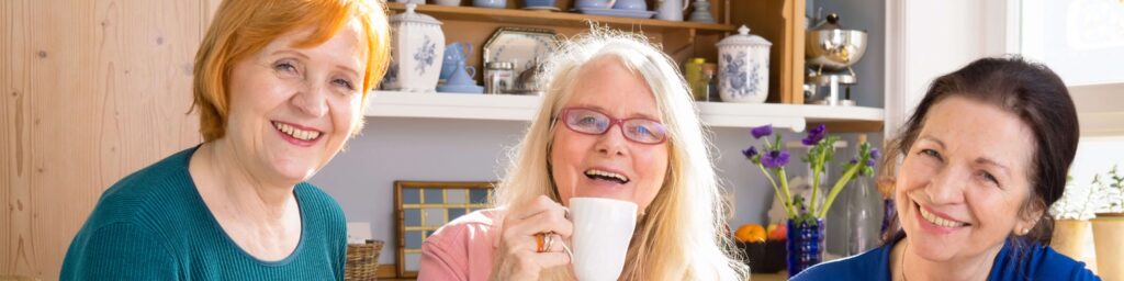 three middle-aged women friends having coffee