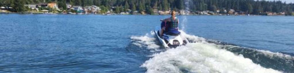 woman riding waverunner on lake