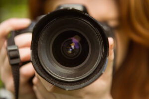 woman taking her own photos with camera for blog