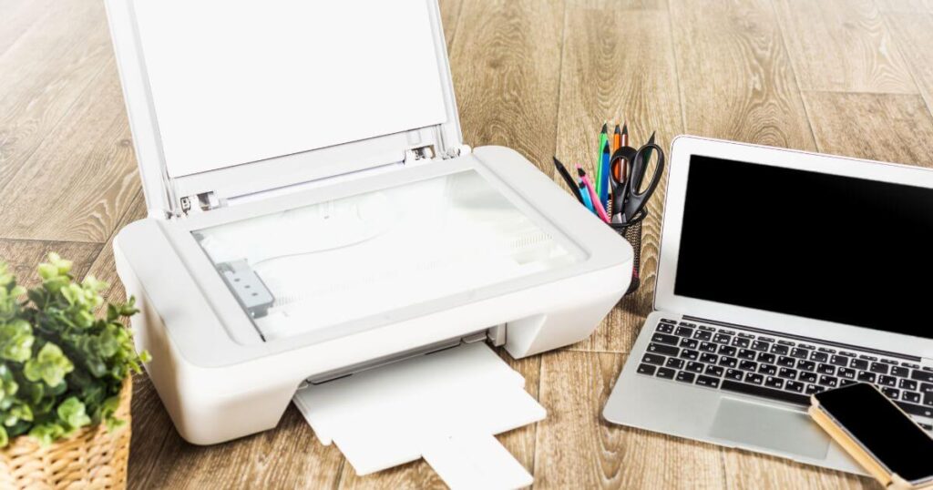 plant printer online business supplies laptop cell phone on desk