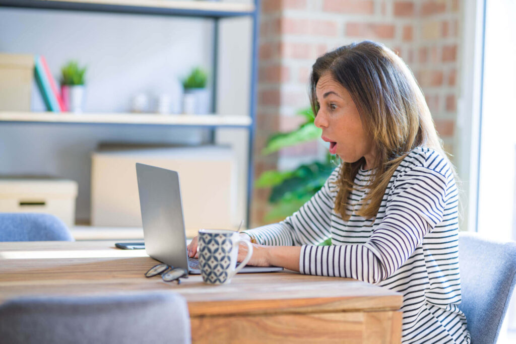 woman working on laptop at desk discovers legal pages needed on website