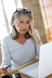 confused woman with laptop computer trying to choose niche