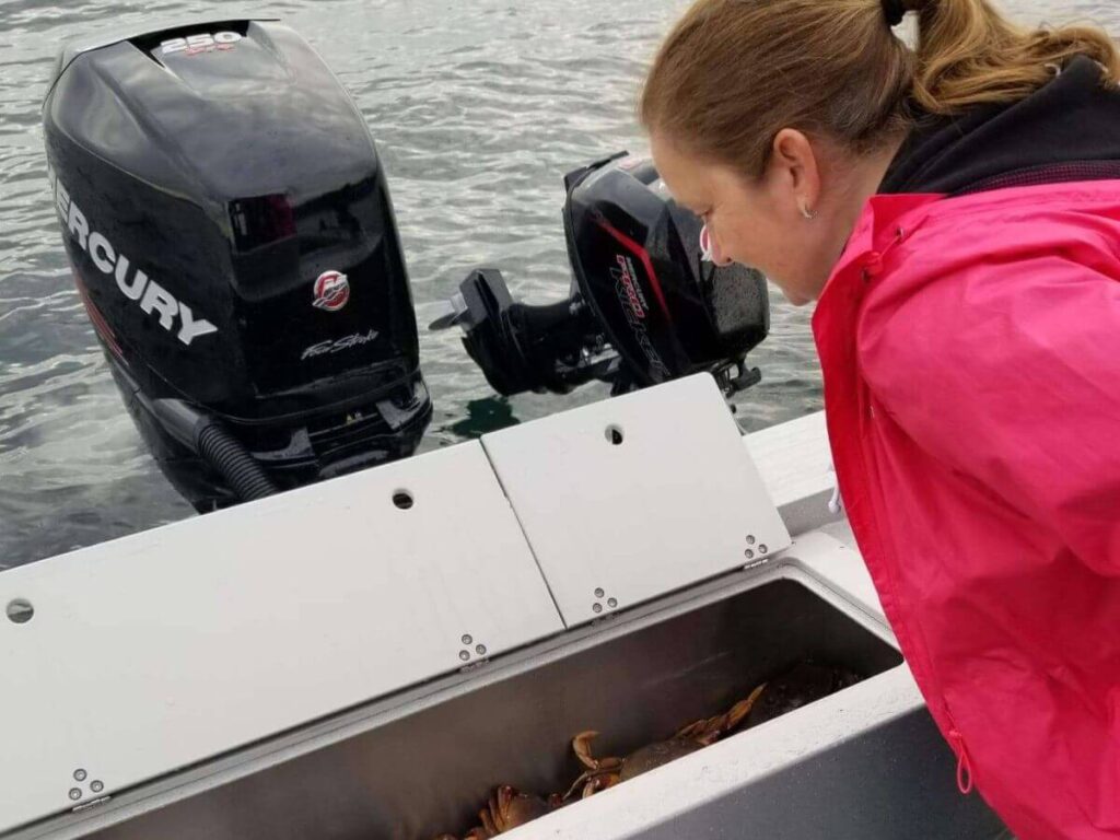 woman on boat counting number of crab caught