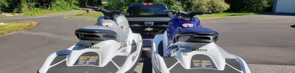 two yamaha personal watercraft waverunners behind truck