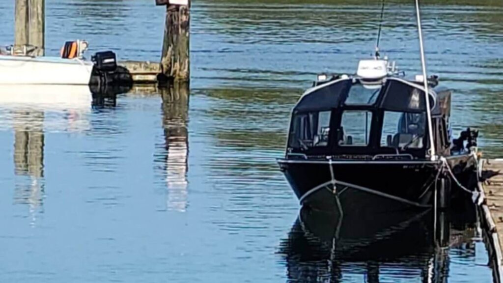boat in water tied to dock