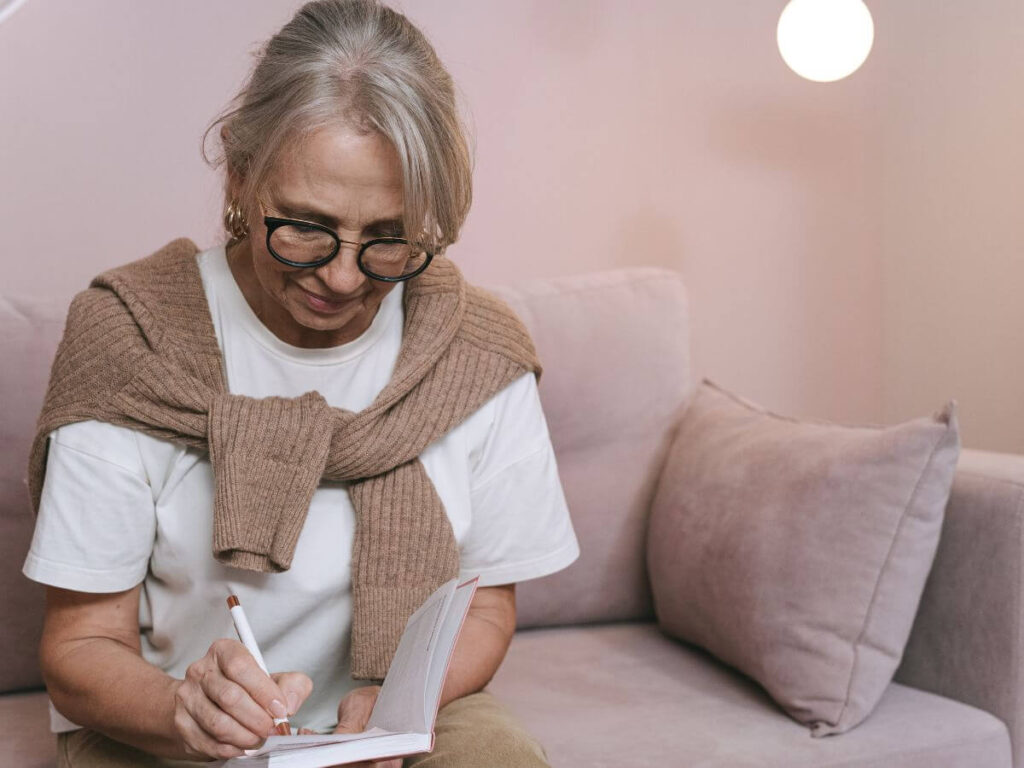 empty nester mom writing in journal