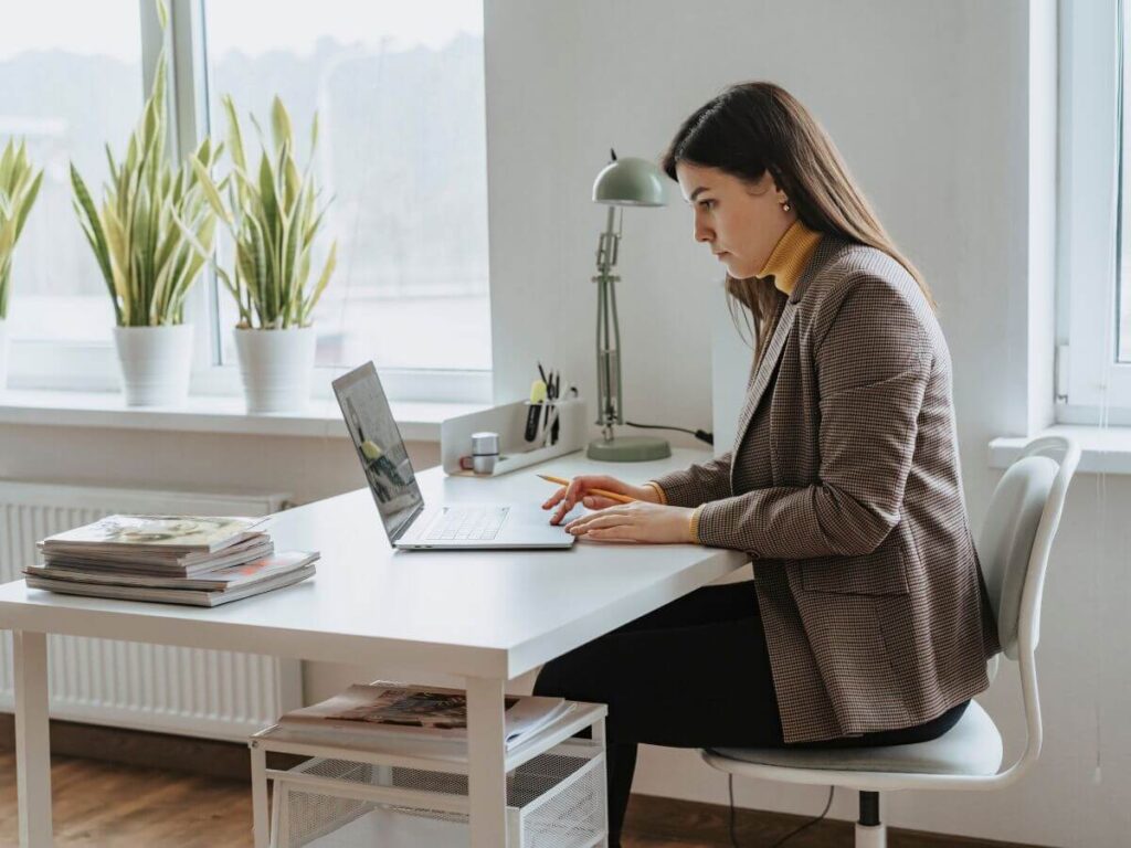 empty nester mom sitting at desk using laptop to explore what to do next