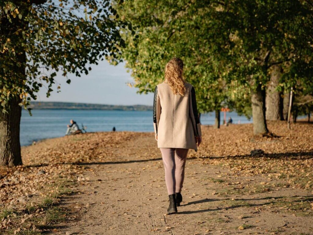 woman walking on trail thinking about empty nester life